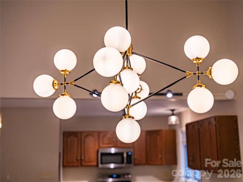 601 Woodfield Drive, Asheville, NC 28803.  MLS# CAR4397478, YatesRealty ID 33736. Elegant and eclectic chandelier above the dining area