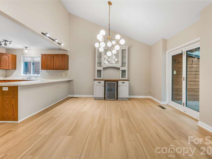601 Woodfield Drive, Asheville, NC 28803.  MLS# CAR4397478, YatesRealty ID 33736. Kitchen opens to the dining area with built in hutch/wine bar with wine cooler.