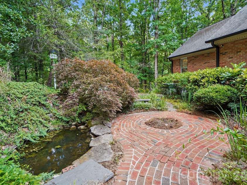 215 Chedworth Court, Concord, NC 28025.  MLS# CAR4396675, YatesRealty ID 33737. Brick path leading through the beautifully landscaped yard