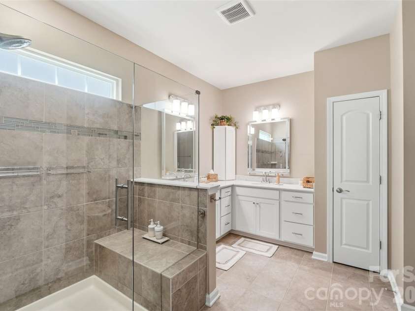 2130 Abundance Lane, Waxhaw, NC 28173.  MLS# CAR4394916, YatesRealty ID 33739. Refreshed spa-style primary bath with custom tile and elevated finishes.