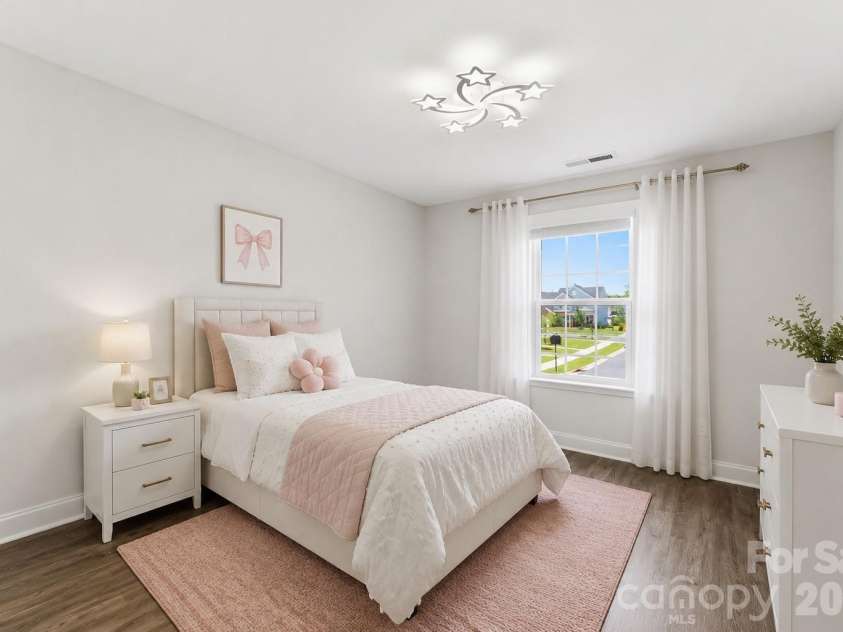 1318 Poppy Way, Matthews, NC 28104.  MLS# CAR4387809, YatesRealty ID 33740. Bedroom #3 features fresh neutral paint, no carpeting, and upgraded lighting. Includes a spacious walk-in closet with custom built-ins. (virtually staged)