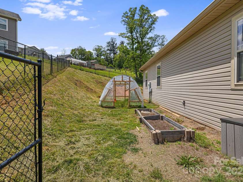 742 Old NC 20 Highway, Alexander, NC 28701.  MLS# CAR4249395, YatesRealty ID 33751. Hoop house and raise beds convey