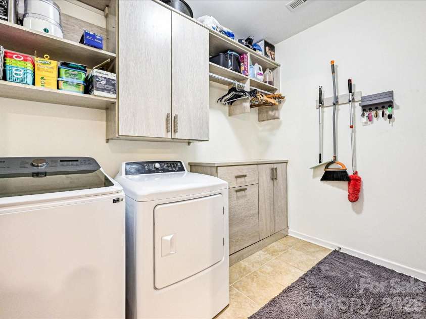 1726 Tailed Hawk Way, Fort Mill, SC 29715.  MLS# CAR4394570, YatesRealty ID 33796. Laundry room with custom cabinets