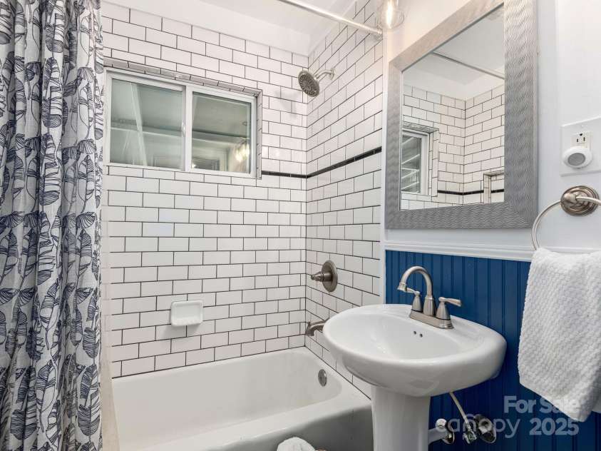 21 Clairmont Avenue, Asheville, NC 28804.  MLS# CAR4251719, YatesRealty ID 33799. Classic tile finishes throughout the main level full bathroom