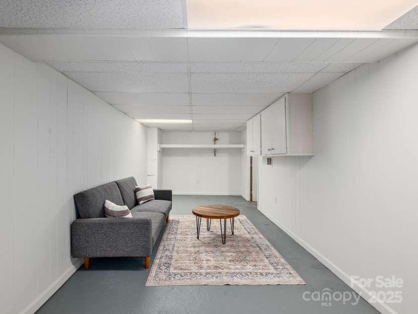 21 Clairmont Avenue, Asheville, NC 28804.  MLS# CAR4251719, YatesRealty ID 33799. Lower level den makes a perfect space to retreat, home studio, or workshop not counted in square footage given it is non contiguous with other heated square footage)