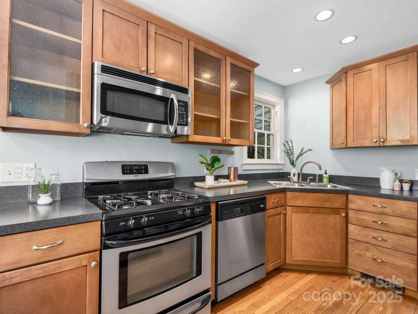 21 Clairmont Avenue, Asheville, NC 28804.  MLS# CAR4251719, YatesRealty ID 33799. Stainless steel appliances and modern finishes complete this spacious kitchen with a functional layout for cooking and entertaining
