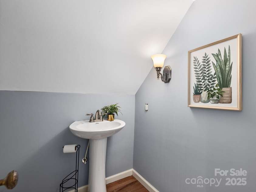 21 Clairmont Avenue, Asheville, NC 28804.  MLS# CAR4251719, YatesRealty ID 33799. Upper level half bathroom highlights architectural details (not counted in square footage due to 6'5