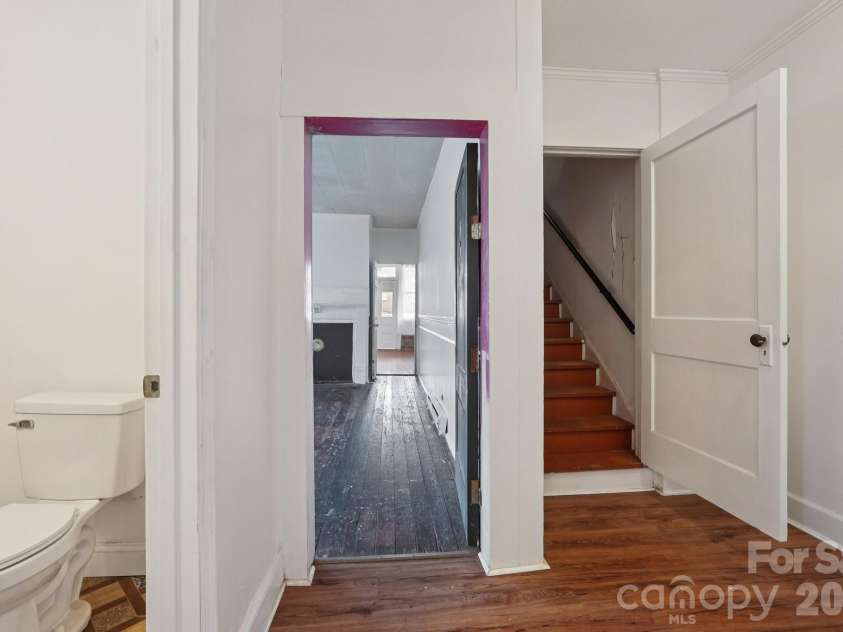 105 Houston Street, Monroe, NC 28112.  MLS# CAR4396106, YatesRealty ID 33807. Primary Unit: Hallway providing access to the upper level while connecting the home's main living spaces.
