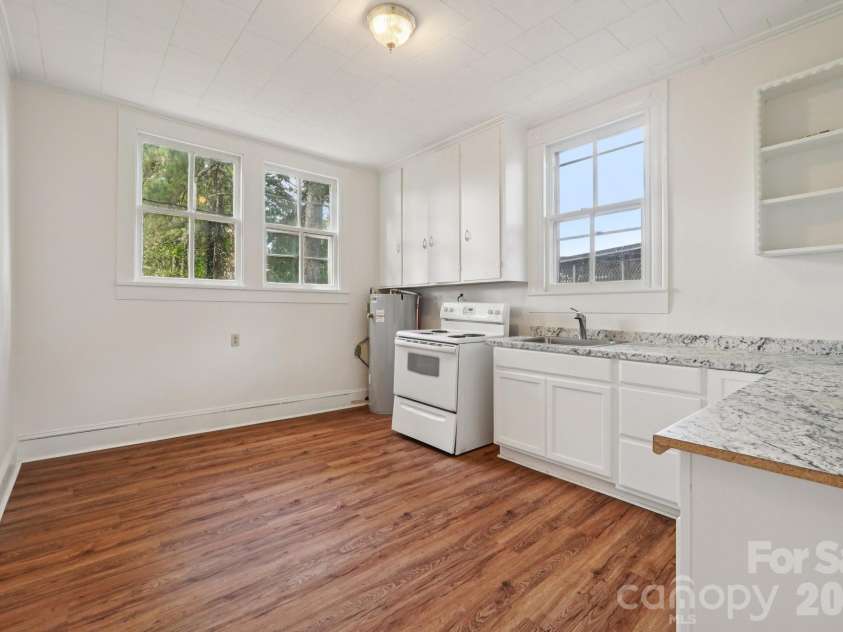 105 Houston Street, Monroe, NC 28112.  MLS# CAR4396106, YatesRealty ID 33807. Primary Unit: Kitchen with abundant cabinetry and a functional layout ready for your personal vision.
