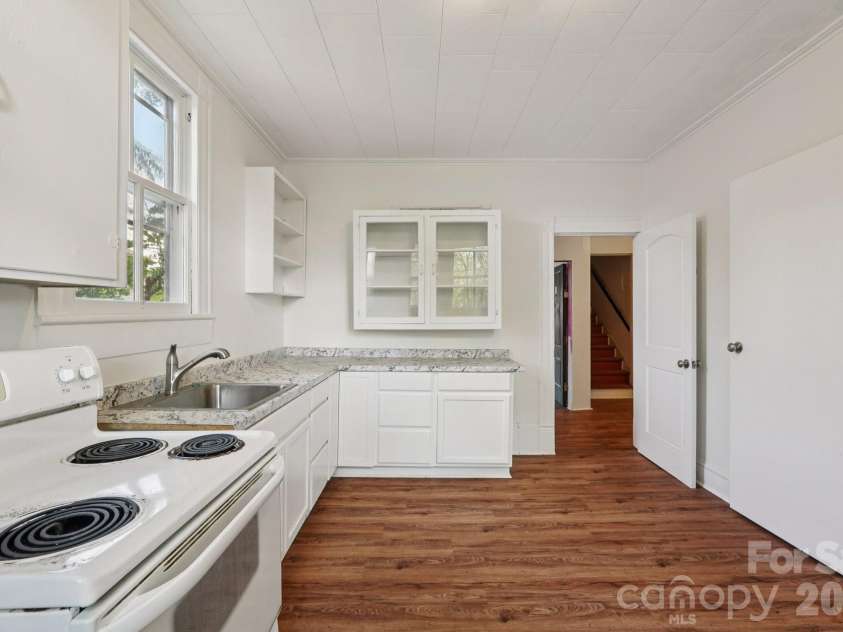 105 Houston Street, Monroe, NC 28112.  MLS# CAR4396106, YatesRealty ID 33807. Primary Unit kitchen with updated glass front cabinets.