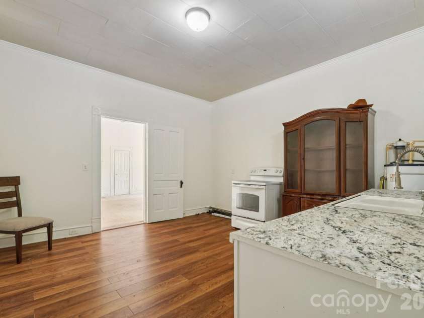 105 Houston Street, Monroe, NC 28112.  MLS# CAR4396106, YatesRealty ID 33807. Secondary Unit: Additional kitchen view illustrating the spacious layout and flexibility for future updates.