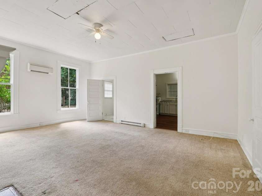 105 Houston Street, Monroe, NC 28112.  MLS# CAR4396106, YatesRealty ID 33807. Secondary Unit: Bedroom offering generous space, natural light, and flexibility for future use.