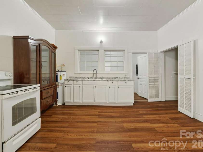 105 Houston Street, Monroe, NC 28112.  MLS# CAR4396106, YatesRealty ID 33807. Secondary Unit: Kitchen offering a functional layout with excellent renovation potential.