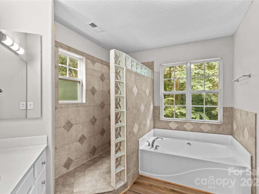 145 Summerbrook Lane, Mooresville, NC 28117.  MLS# CAR4280229, YatesRealty ID 33808. Tiled Shower and Soaking Tub