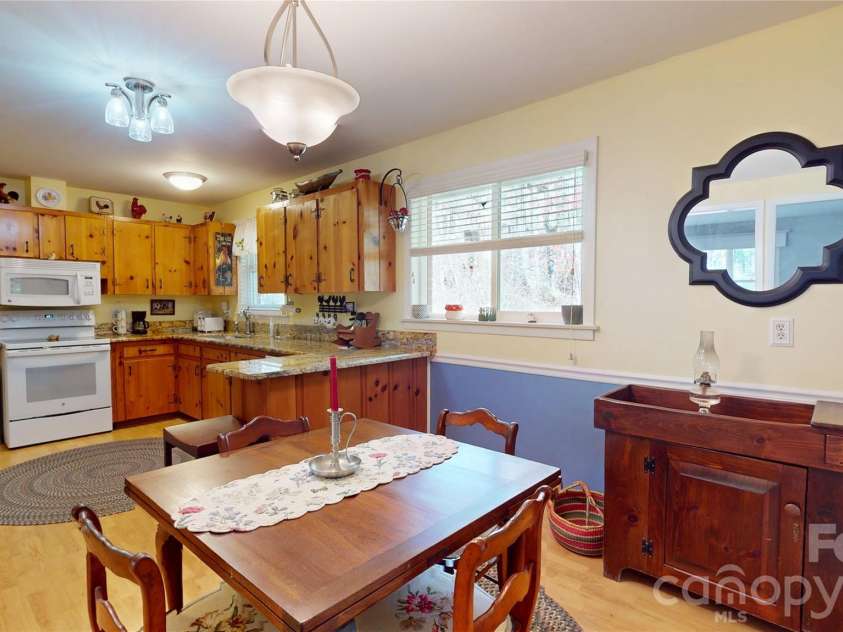 979 Greenville Highway, Brevard, NC 28712.  MLS# CAR4338067, YatesRealty ID 33808. Kitchen and dining with bar.