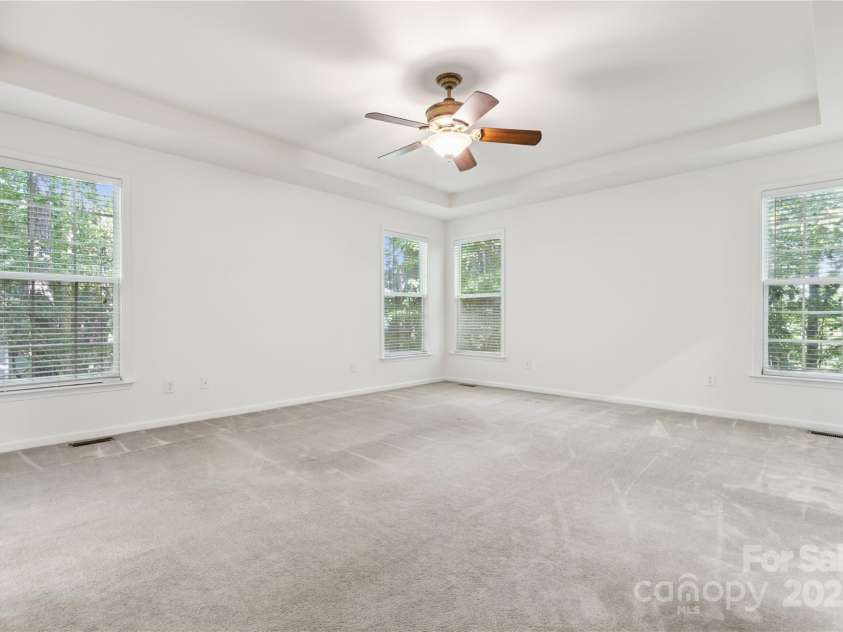 1627 Scotch Pine Lane, Tega Cay, SC 29708.  MLS# CAR4281753, YatesRealty ID 33813. Tray ceiling and fan in Primary bedroom #1