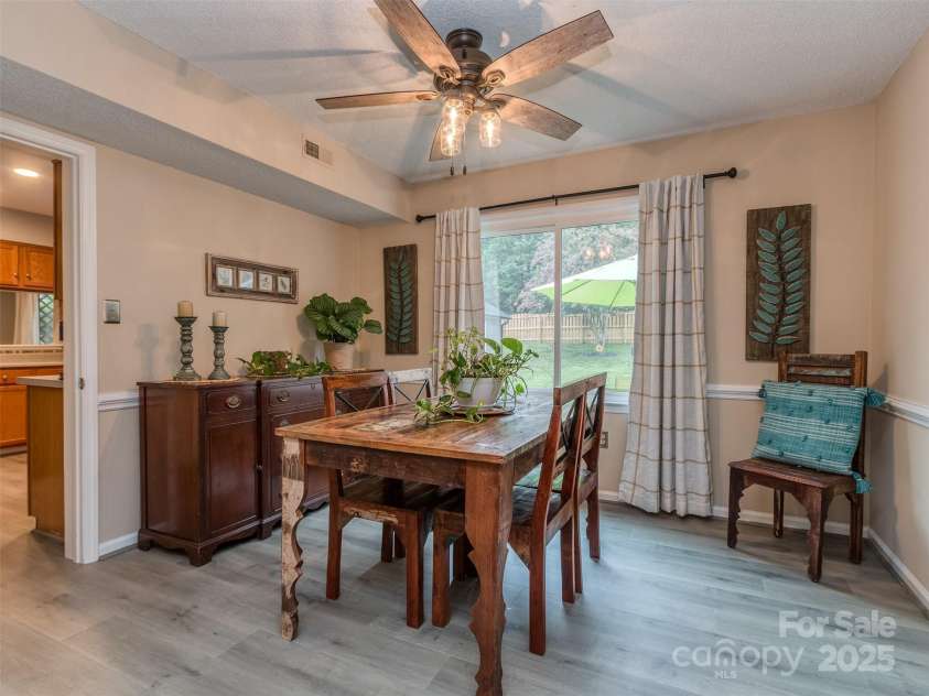 8715 Parkchester Drive, Charlotte, NC 28277.  MLS# CAR4288901, YatesRealty ID 33815. The Formal Dining Room has chair rail, laminate wood floors, and views of the private, fenced rear yard.