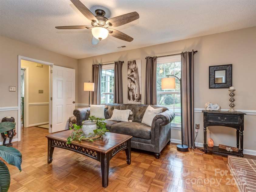 8715 Parkchester Drive, Charlotte, NC 28277.  MLS# CAR4288901, YatesRealty ID 33815. The open Great Room has pristine Parquet wood floors, chair rail, & wood burning fireplace with brick hearth & surround with mantle.