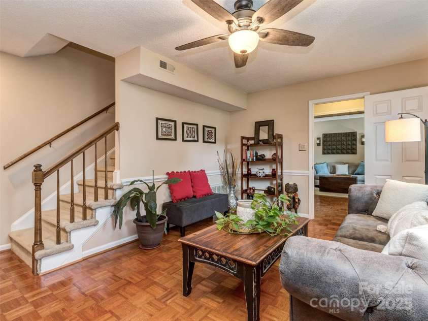 8715 Parkchester Drive, Charlotte, NC 28277.  MLS# CAR4288901, YatesRealty ID 33815. The open Great Room has pristine Parquet wood floors, chair rail, & wood burning fireplace with brick hearth & surround with mantle.