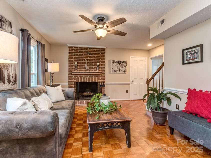 8715 Parkchester Drive, Charlotte, NC 28277.  MLS# CAR4288901, YatesRealty ID 33815. The open Great Room has pristine Parquet wood floors, chair rail, & wood burning fireplace with brick hearth & surround with mantle.