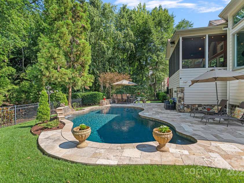 17018 Laurelmont Court, Fort Mill, SC 29707.  MLS# CAR4278414, YatesRealty ID 33822. Stunning salt water pool and travertine pool decking