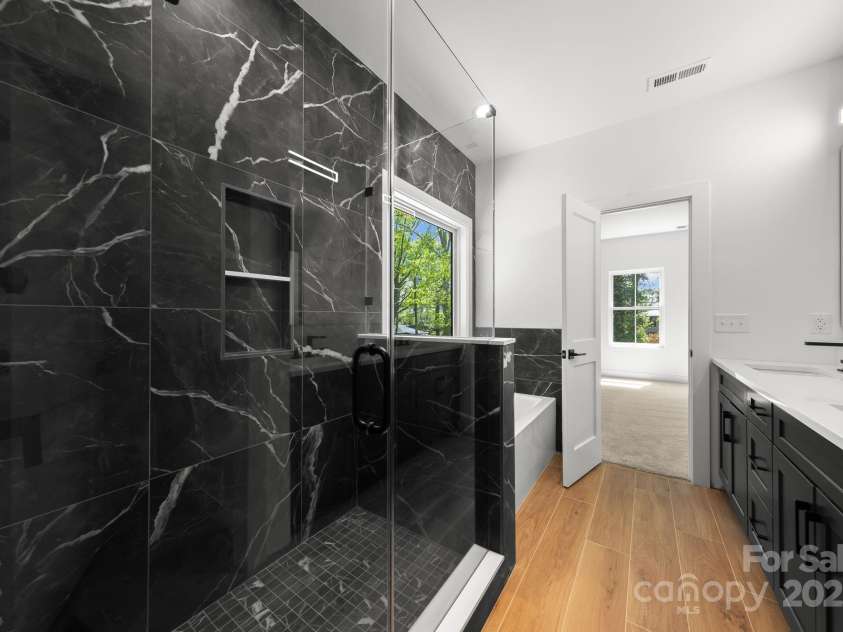 2006 St John Street, Charlotte, NC 28216.  MLS# CAR4255545, YatesRealty ID 33830. Luxurious primary shower & Soaking tub