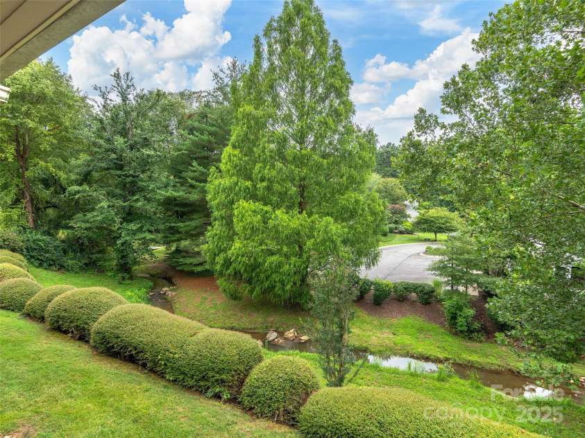 13 Timberlake Drive, Asheville, NC 28803.  MLS# CAR4289602, YatesRealty ID 33852. Little creek seen from balcony. Not in flood zone!