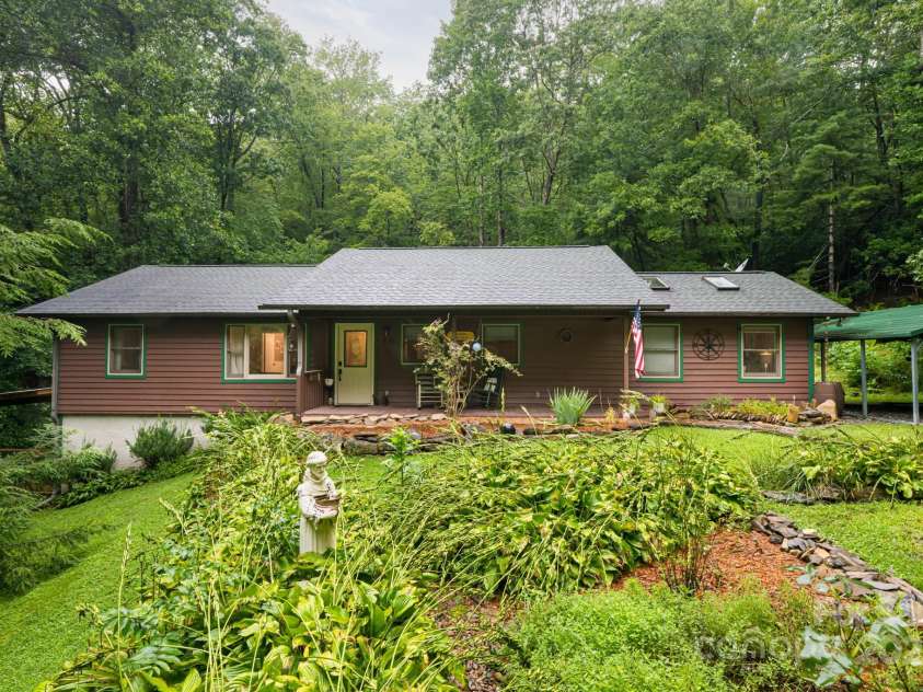 19 Forge Drive, Mills River, NC 28759.  MLS# CAR4289145, YatesRealty ID 33856. Lush Landscaping and Mature Trees Frame the Home