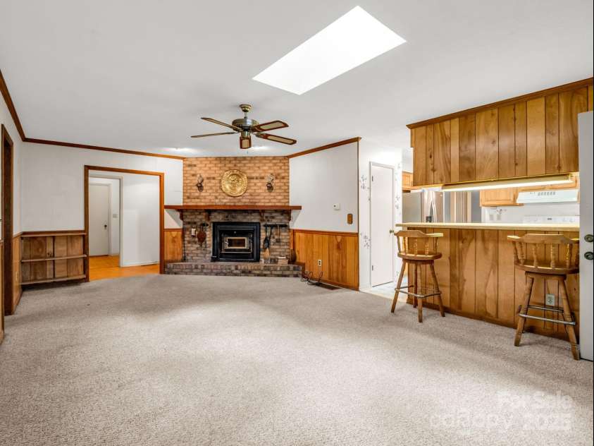 845 Greenwood Drive, Hendersonville, NC 28791.  MLS# CAR4290151, YatesRealty ID 33859. Family room with fireplace