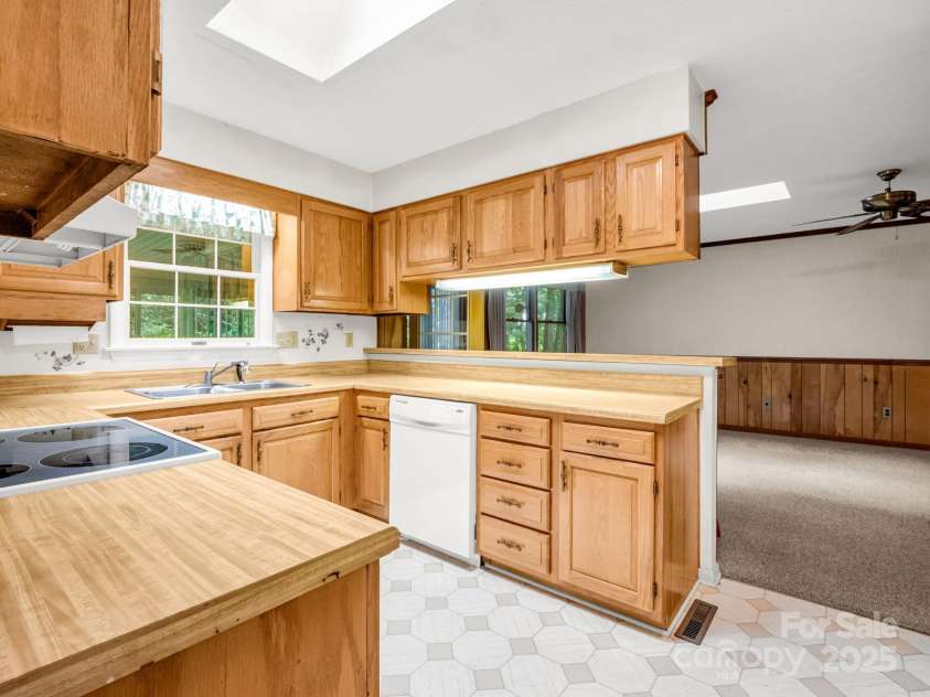 845 Greenwood Drive, Hendersonville, NC 28791.  MLS# CAR4290151, YatesRealty ID 33859. Kitchen flows to family room