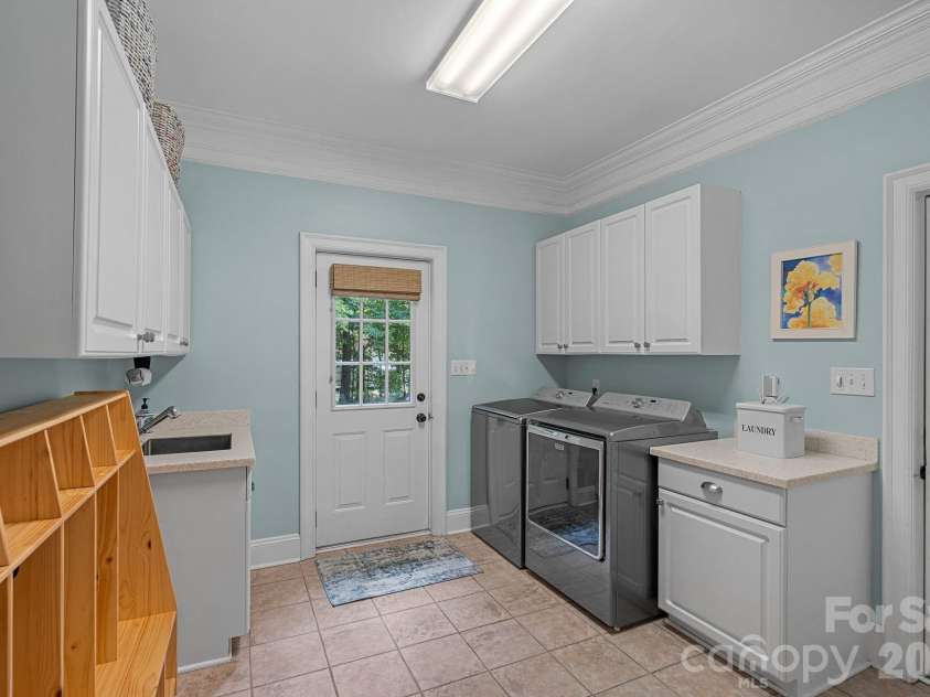 1317 Longleaf Court, Matthews, NC 28104.  MLS# CAR4349389, YatesRealty ID 3386. Main level Laundry has sink & cabinets