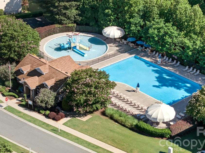 103 Cranbrook Lane, Mooresville, NC 28117.  MLS# CAR4392478, YatesRealty ID 33887. Generously sized community pool featuring a children's water park area and covered umbrella seating.