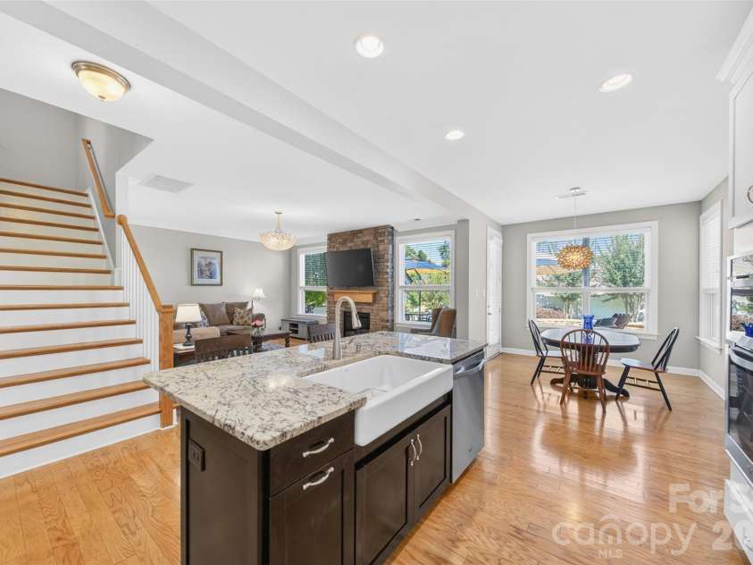 103 Cranbrook Lane, Mooresville, NC 28117.  MLS# CAR4392478, YatesRealty ID 33887. Large center island opening to the den with rich hardwood floors throughout.