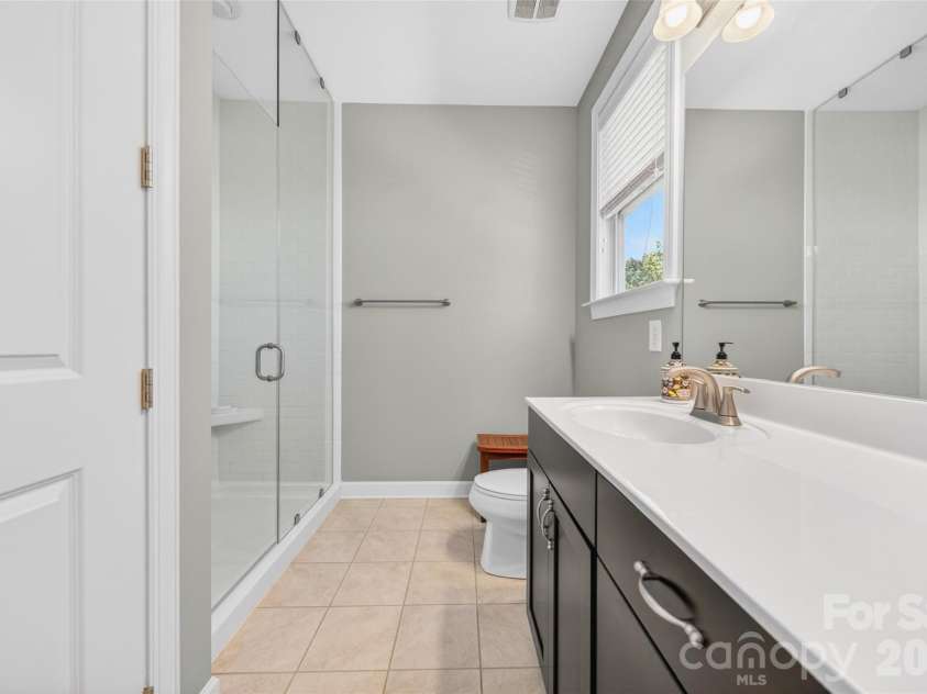 103 Cranbrook Lane, Mooresville, NC 28117.  MLS# CAR4392478, YatesRealty ID 33887. Spa-like primary bath featuring an extended double vanity, dual sinks, and glass-enclosed shower.