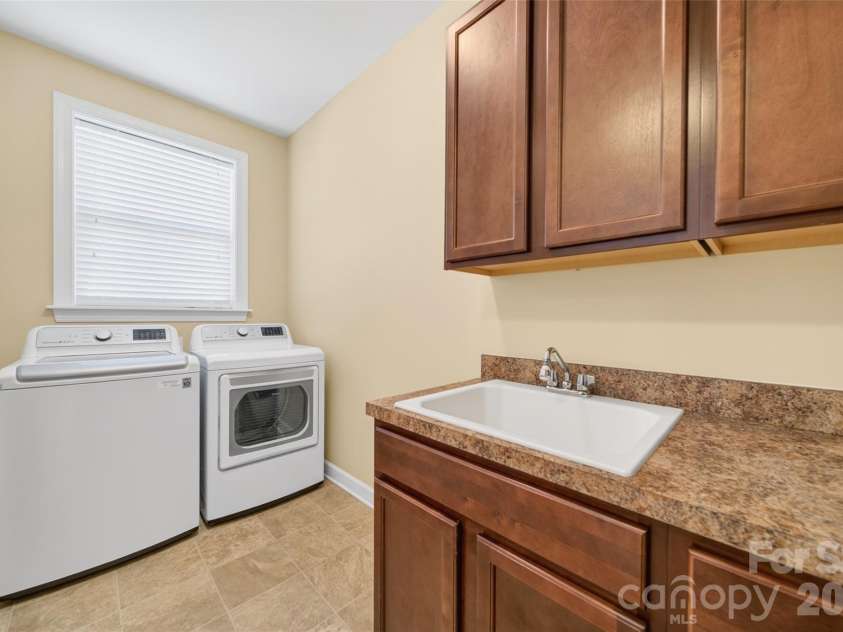 103 Cranbrook Lane, Mooresville, NC 28117.  MLS# CAR4392478, YatesRealty ID 33887. Spacious laundry room with ample cabinetry and countertop space, accessible directly from the garage.