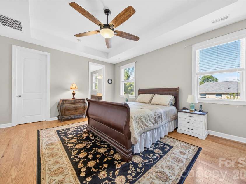 103 Cranbrook Lane, Mooresville, NC 28117.  MLS# CAR4392478, YatesRealty ID 33887. Spacious primary bedroom featuring dual windows and two separate walk-in closets.