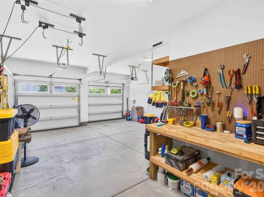 103 Cranbrook Lane, Mooresville, NC 28117.  MLS# CAR4392478, YatesRealty ID 33887. Spacious two-car garage featuring two individual doors and a dedicated built-in workbench area.