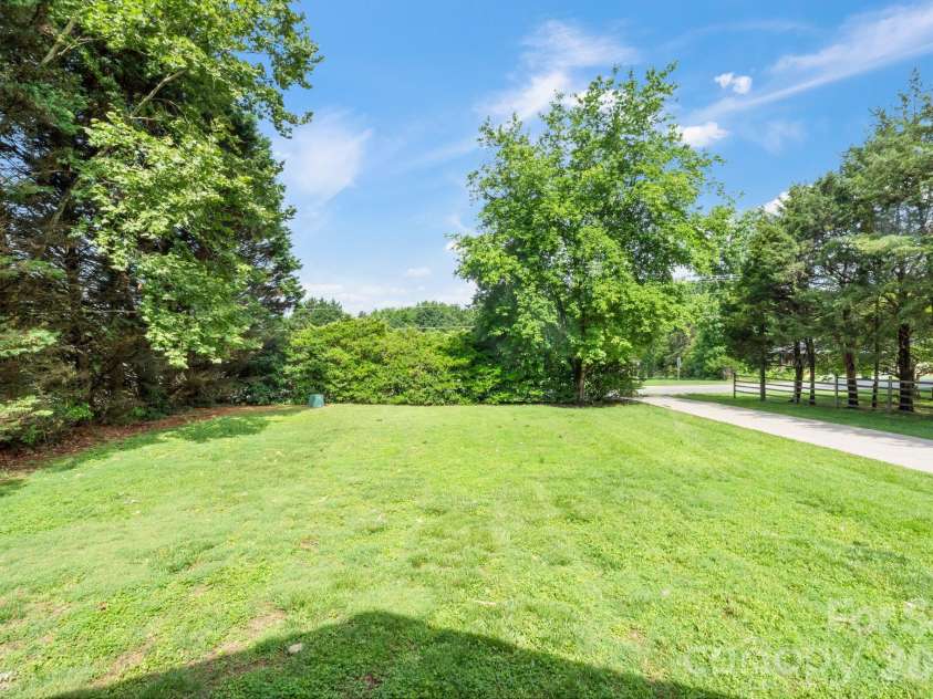 6168 King Wilkinson Road, Denver, NC 28037.  MLS# CAR4395555, YatesRealty ID 33896. Large front yard with privacy landscaping 