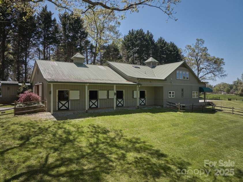 201 Hughes Creek, Columbus, NC 28722.  MLS# CAR4259120, YatesRealty ID 339. Center aisle barn with 4 stalls, wash rack, tack room, and high-end barn apartment