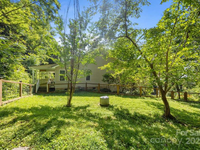 73 Waters Road, Asheville, NC 28805.  MLS# CAR4272719, YatesRealty ID 33907. Fully fenced, pet-friendly yard surrounded by lush natural privacy.