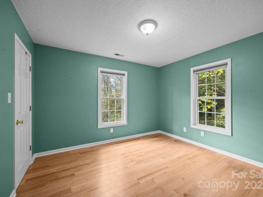 73 Waters Road, Asheville, NC 28805.  MLS# CAR4272719, YatesRealty ID 33907. Guest Bedroom #2: Peaceful corner room with natural light, perfect for a serene home office.