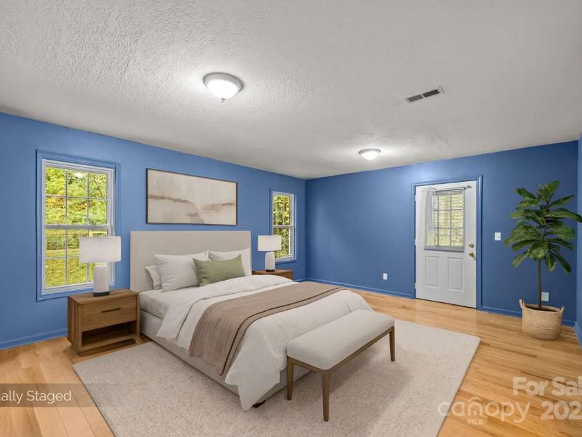 73 Waters Road, Asheville, NC 28805.  MLS# CAR4272719, YatesRealty ID 33907. Large primary ensuite bedroom w/ walk-in closet and walkout access to covered back porch.