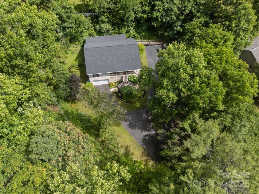 73 Waters Road, Asheville, NC 28805.  MLS# CAR4272719, YatesRealty ID 33907. Nestled in lush Haw Creek foliage with a long, private approach that keeps the world at a distance.