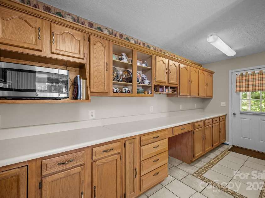 73 Waters Road, Asheville, NC 28805.  MLS# CAR4272719, YatesRealty ID 33907. Wrap-Around Kitchen leading to covered back porch for peaceful mornings.