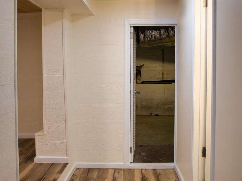 107 Riverview Drive, Asheville, NC 28806.  MLS# CAR4275298, YatesRealty ID 33909. Basement Hallway to Storage Area