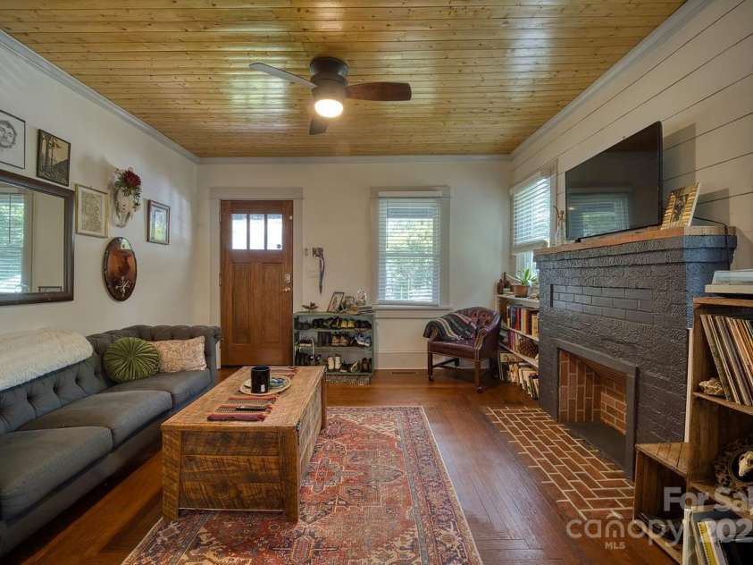 107 Riverview Drive, Asheville, NC 28806.  MLS# CAR4275298, YatesRealty ID 33909. Original Hardwood Floors and Hearth in Living Room