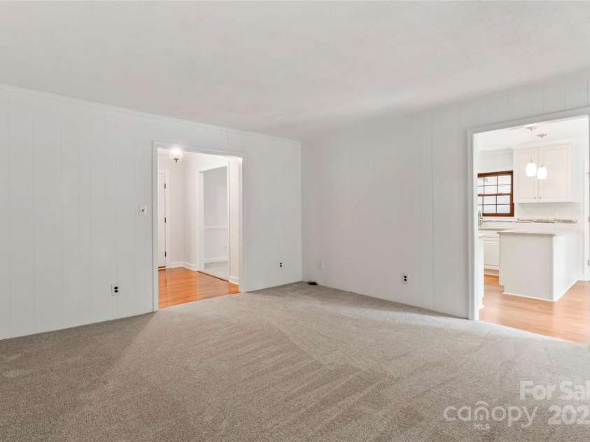 5812 Chapel Creek Court, Charlotte, NC 28226.  MLS# CAR4293995, YatesRealty ID 33915. Family room with log burning fireplace with access to Kitchen, Sunroom and Entrance