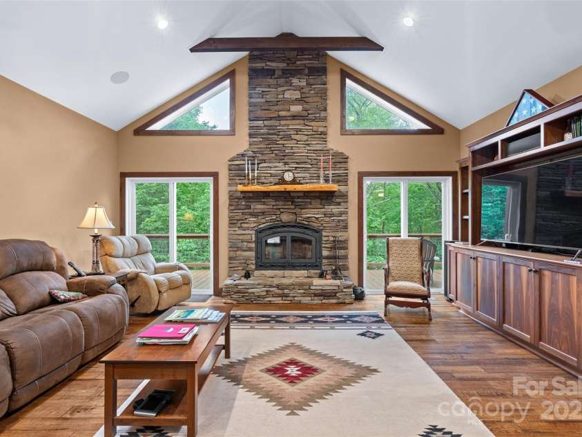 55 Lake Drive, Fairview, NC 28730.  MLS# CAR4272386, YatesRealty ID 33918. Dramatic fireplace in light-filled living room