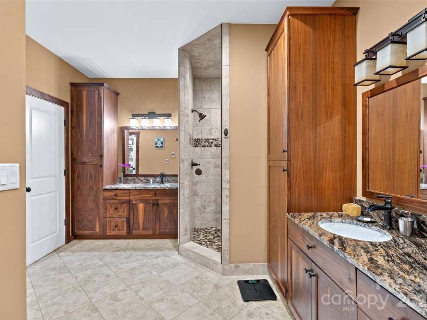 55 Lake Drive, Fairview, NC 28730.  MLS# CAR4272386, YatesRealty ID 33918. En suite bathroom with shower, tub and double sink
