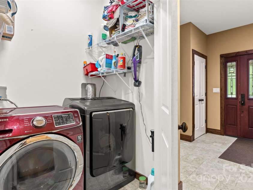 55 Lake Drive, Fairview, NC 28730.  MLS# CAR4272386, YatesRealty ID 33918. Laundry in hall off primary bedroom on main level